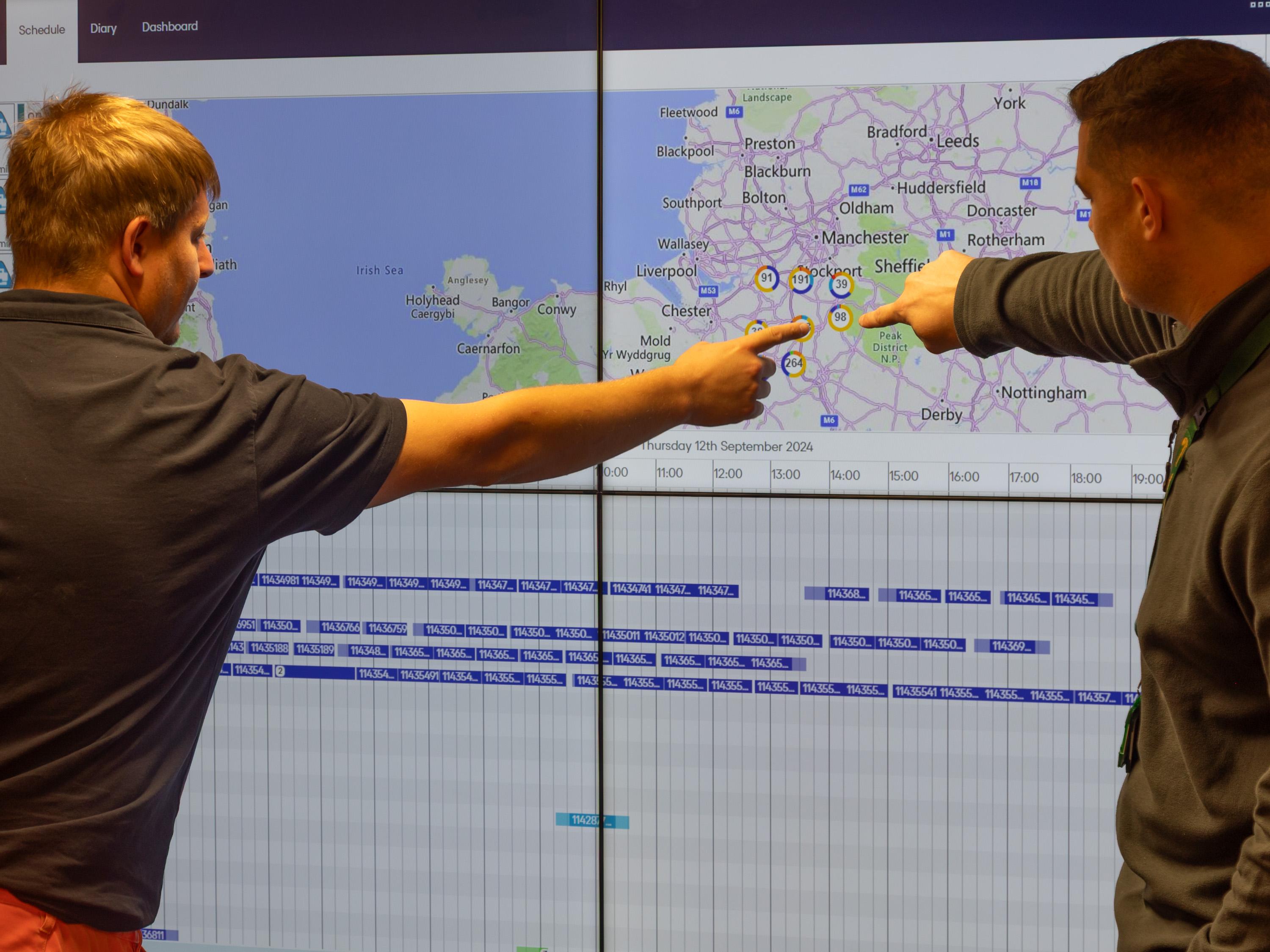 Ringway Jacobs Engineers reviewing live highways data and digital mapping on large control room display